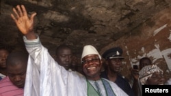 Sierra Leone's incumbent President Ernest Bai Koroma waves to supporters after voting in the capital, Freetown, November 17, 2012.