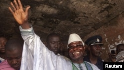 Sierra Leone's incumbent President Ernest Bai Koroma waves to supporters after voting in the capital, Freetown, November 17, 2012.