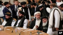 Taliban official Abdul Salam Hanafi, center, and other members of the political delegation from the Afghan Taliban's movement arrive to attend the talks involving Afghan representatives in Moscow, Russia, Oct. 20, 2021.