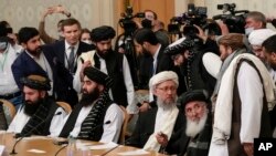 Taliban official Abdul Salam Hanafi, center, and other members of the political delegation from the Afghan Taliban's movement arrive to attend the talks involving Afghan representatives in Moscow, Russia, Oct. 20, 2021.