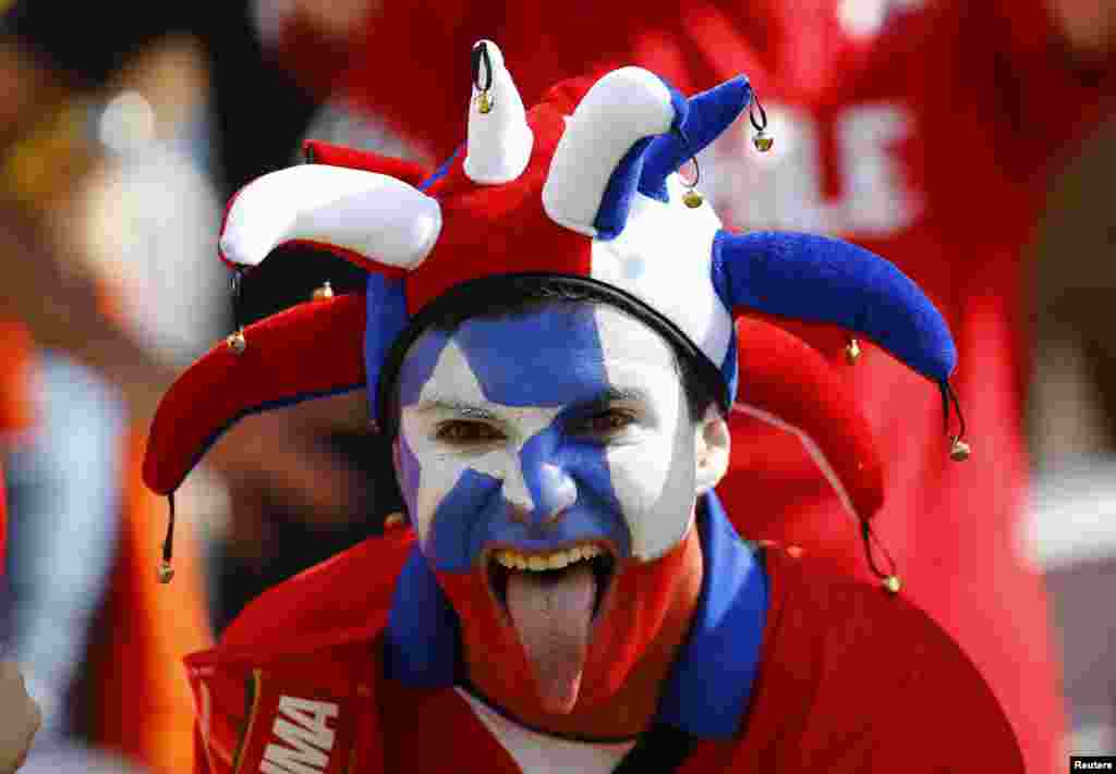 A Chilean fan poses for the camera before the start of the match against Netherlands at the Corinthians arena in Sao Paulo, June 23, 2014.