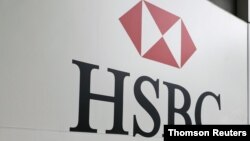 FILE - A sign for the British bank and financial services giant HSBC.