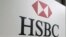 FILE - A sign for the British bank and financial services giant HSBC.
