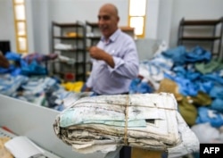 A picture taken on Aug. 14, 2018 shows a stack stack of letters and postcards, among many items of undelivered mail dating as far back as 2010 which has been withheld by Israel.