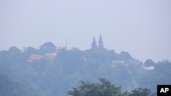 A thick layer of smog covers Wat Phra That Doi Suthep in Chiang Mai province, Thailand, Tuesday, April 2, 2019. (AP Photo/Maytanan Merchant)