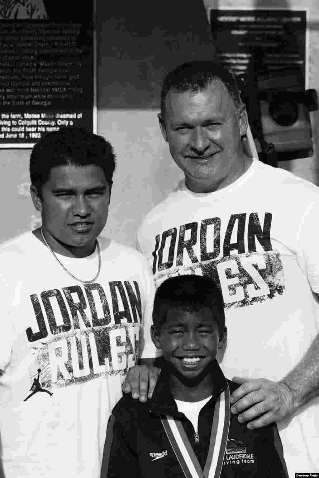 Jordan Pisey Windle, a five-time national champions, posed for a picture after the competition with his two-male parents, Jerry Windle and Andres Rodriguez. (Courtesy Photo)