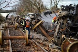 People work at the scene of a train derailment after a devastating outbreak of tornadoes ripped through several U.S. states in Earlington, Kentucky, U.S. Dec.