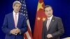 China's Foreign Minister Wang Yi (R) listens while US Secretary of State John Kerry talks before a bilateral meeting at the Putra World Trade Center Aug. 5, 2015 in Kuala Lumpur, Malaysia.