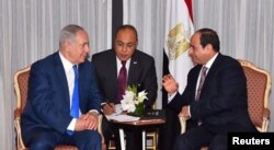 Egyptian President Abdel Fattah el-Sissi, right, speaks with Israeli Prime Minister Benjamin Netanyahu, left, during their meeting as part of an effort to revive the Middle East peace process ahead of the United Nations General Assembly in New York, Sept. 19, 2017 in this handout picture courtesy of the Egyptian Presidency.