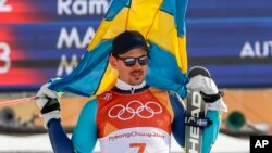 Andre Myhrer of Sweden celebrates his gold medal during the venue ceremony after the men's slalom at the 2018 Winter Olympics in Pyeongchang, South Korea, Feb. 22, 2018.