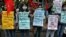 Students wearing protective face masks hold placards as they participate in a protest march demanding postponement of admission tests to medical and engineering schools amidst the spread of COVID-19, in Kolkata, India, Aug. 29, 2020.