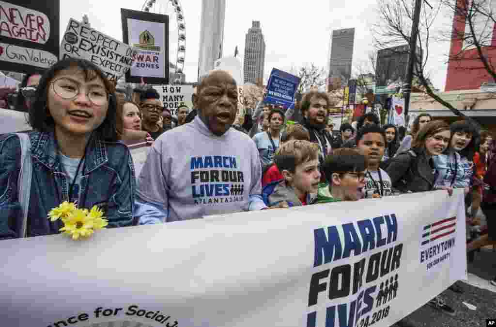 U.S. Rep. John Lewis leads a march of thousands through the streets of Atlanta on Saturday, March 24, 2018.&nbsp;