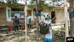 A woman casts her ballot at a polling station during Tigray’s regional elections, in the town of Tikul, 15 kms east from Mekele, Ethiopia, Sept. 9, 2020.