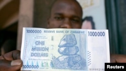 FILE: A black market foreign currency dealer displays the new $1 million banknote worth $7 on the streets of Harare, October 6, 2008.