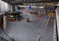 A passenger walks at the airport in Frankfurt, Germany, on April 9, 2020. About 95 percent of the flights were canceled because of the coronavirus.
