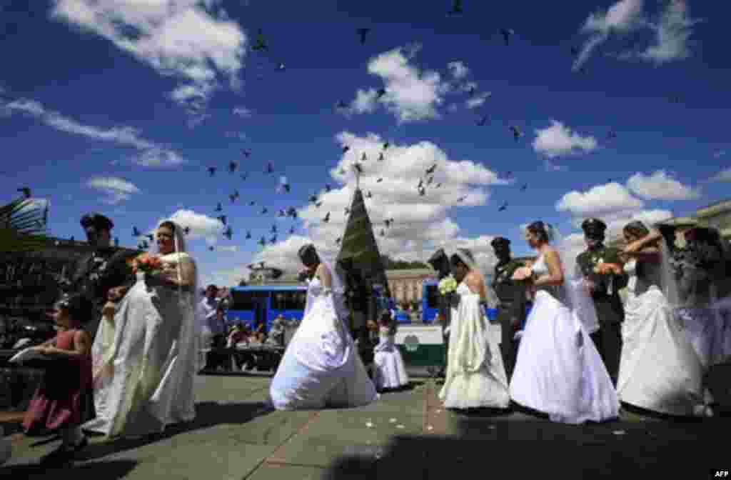 Couples walk together before getting married at a collective Catholic wedding for 97 police officers and their fiancees at the Cathedral in Bogota, Colombia, Friday Dec. 9, 2011. Every year before Christmas the police organize a mass wedding for officers.
