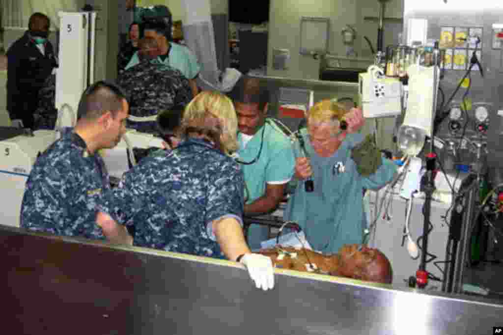 Doctors, nurses and medics on the USNS Comfort, a hospital ship, work on a Haitian aboard the ship now off the coast of Haiti, 20 Jan 2010 - DoD photo/Jim Garamone