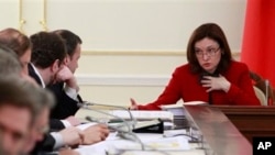 Russian presidential aide Elvira Nabiullina, right, at a meeting on fuel and energy, Novo-Ogaryovo residence, near Moscow, Feb. 13, 2013.