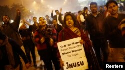 Demonstrators shout slogans during candlelight vigil marking first anniversary of deadly gang rape, New Delhi, Dec. 16, 2013.