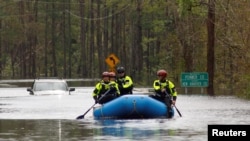 A search and rescue task force patrols a flooded region by boat over a fully submerged road in the aftermath of Hurricane Florence in Castle Hayne, North Carolina, Sept. 17, 2018. 