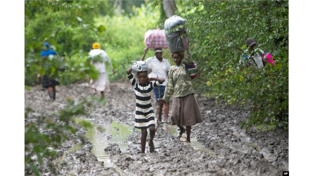Villagers carry food for people taking care of their livestock in Tsholostho, about 200 kilometers north of Bulawayo, March 4, 2017.