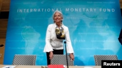 Tổng giám đốc IMF Christine Lagarde đến dự họp báo tại trự sở IMF ở thủ đô Washington, ngày 14 tháng 6, 2013. (REUTERS/Jose Luis Magana )