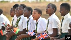 School children sing as they wait for a visit by Britain's Prince Harry, at Nalikule College of Education in Malawi, Sept. 29, 2019.