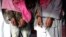 Two men in handcuffs, whom the police said belong to the Tehreek-e-Taliban Pakistan [TTP] group, are shown during a news conference at the Crime Investigation Department after their arrest, in Karachi, January 2013.