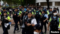 Police stand guard outside the West Kowloon Magistrates' Courts building during the verdict of the 47 pro-democracy activists charged under the national security law, in Hong Kong. May 30, 2024