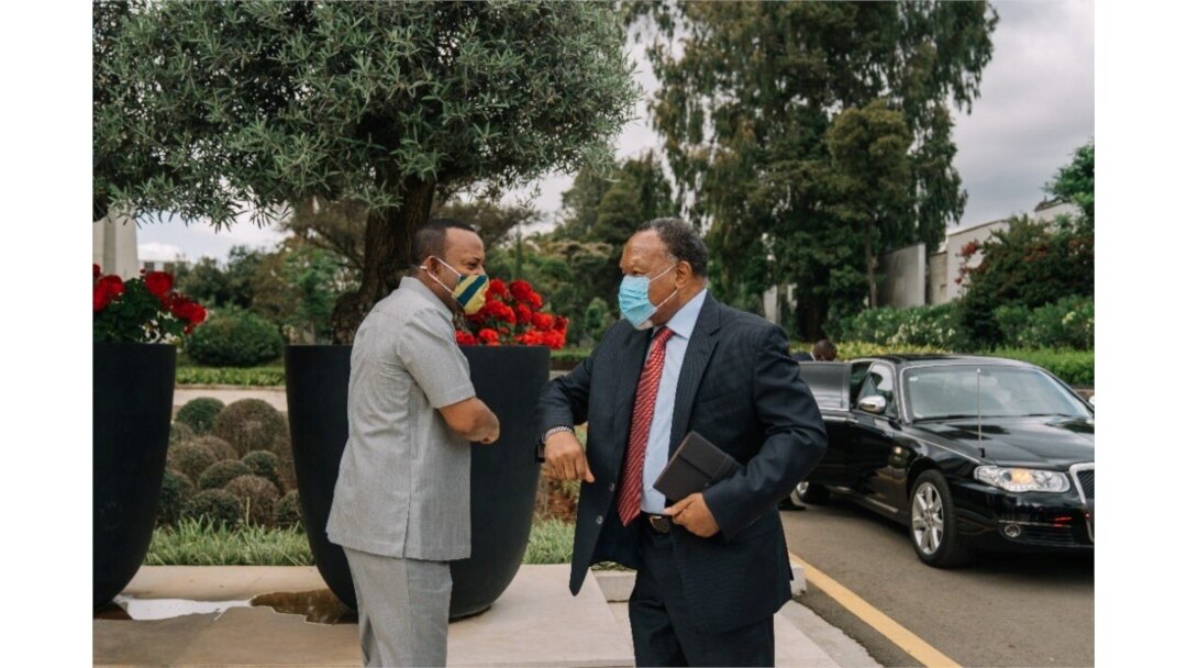 Ethiopian Prime Minister Abiy Ahmed greets an African Union envoy in Addis Ababa, Ethiopia, Nov. 27, 2020, in this picture obtained from social media.
