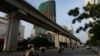 FILE - Motorcyclists ride past the Chinese-funded elevated train line in Hanoi, Vietnam, September 12, 2014.