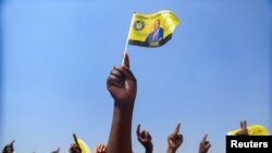 FILE - A supporter of Zimbabwe's main opposition leader and leader of Citizens Coalition for Change (CCC), Nelson Chamisa waves a flag during the party's final rally ahead of the elections in Harare, Zimbabwe, August 21, 2023