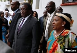 Zimbabwean President Emmerson Mnangagwa and his wife Auxillia arrive to pay their respects at the home of Movement For Democratic Change (MDC) leader Morgan Tsvangirai in Harare, Zimbabwe, Feb. 18, 2018.