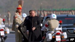 FILE - Pakistan's prime minister Nawaz Sharif, center, arrives to attend a military parade to mark Pakistan's Republic Day, in Islamabad, Pakistan, Thursday, March 23, 2017.