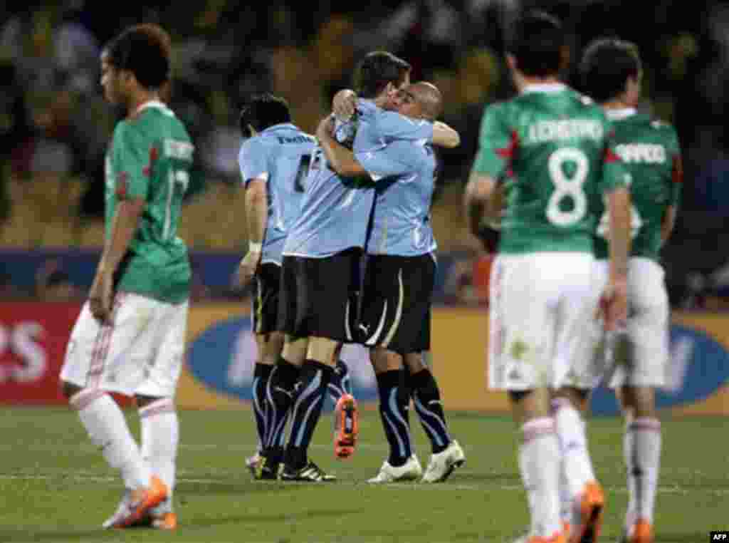 Uruguay players celebrate at the end of the World Cup group A soccer match between Mexico and Uruguay at Royal Bafokeng Stadium in Rustenburg, South Africa, on Tuesday, June 22, 2010. Uruguay won 1-0. (AP Photo/Ivan Sekretarev)