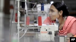 FILE - Bangladeshi garment worker Asma, who worked on the 4th floor of Rana Plaza garment factory, works at a factory meant to rehabilitate survivors of the accident.