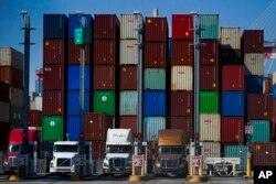 FILE - Containers are stacked at the Port of Long Beach in California, Oct. 1, 2021.