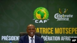 FILE - CAF President Patrice Motsepe smiles during a news conference in Johannesburg, South Africa, March 16, 2021.