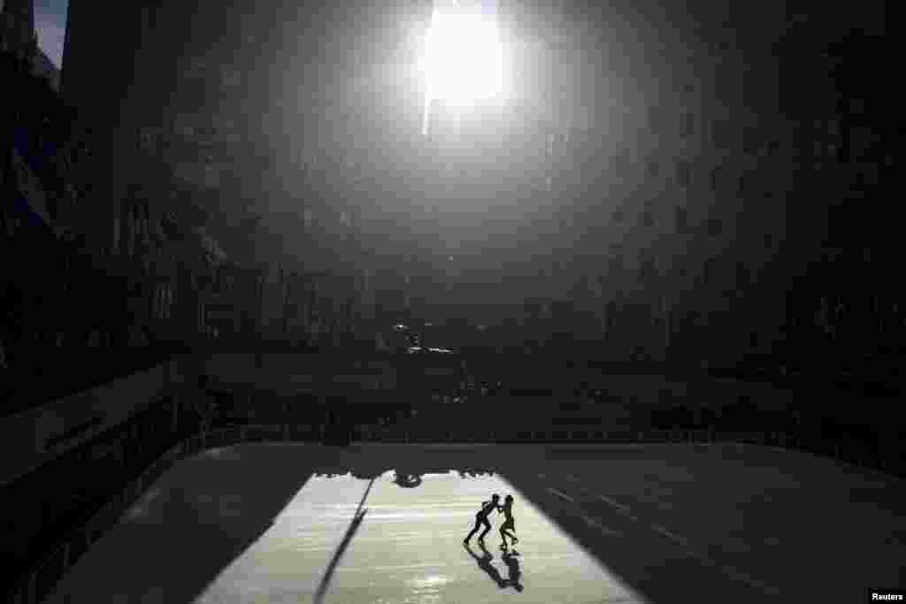 Olympic gold medal ice dancers Meryl Davis (R) and Charlie White skate on The Rink at Rockefeller Center as the first skaters to kick off the winter season as the rink is now open to the public in the Manhattan borough of New York.