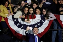 Democratic presidential candidate former South Bend, Ind., Mayor Pete Buttigieg takes a selfie with supporters after speaking at a caucus night campaign rally, Feb. 3, 2020, in Des Moines, Iowa.