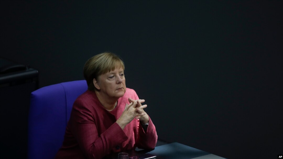German Chancellor Angela Merkel listens to the debate about her policy as part of Germany's budget 2021 debate at the parliament Bundestag in Berlin, Germany, Sept. 30, 2020.