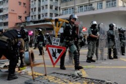 Riot police remove barricades erected by demonstrators during a protest in Hong Kong, Oct. 12, 2019.