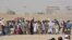 People en route to Afghanistan wait at the Pakistani border post in Chaman, in southwest Pakistan, Aug. 31, 2016. 
