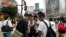 High school students play the augmented reality mobile game "Pokemon Go" by Nintendo on their mobile phone in front of a busy crossing in Shibuya district in Tokyo, Japan, July 22, 2016. 