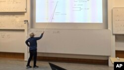 Nobel laureate Anne L'Huillier, who is one of this year's Nobel laureates in Physics, holds a lecture after being notified about the award, at the Lund University, in Lund, Sweden, on Tuesday, Oct. 3, 2023. (Aron Allen via AP)