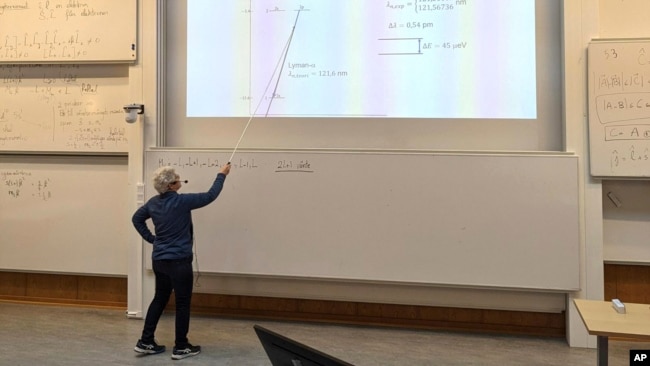 Nobel laureate Anne L'Huillier, who is one of this year's Nobel laureates in Physics, holds a lecture after being notified about the award, at the Lund University, in Lund, Sweden, on Tuesday, Oct. 3, 2023. (Aron Allen via AP)