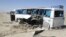 The wreckage of a bus that was damaged in a roadside bomb blast sits beside a road in Ghazni, Afghanistan, July 1, 2012. 