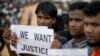 Rohingya refugees holding placards, await the arrival of a U.N. Security Council team at the Kutupalong Rohingya refugee camp in Kutupalong, Bangladesh, on April 29, 2018.