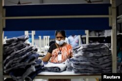 FILE - An employee sorts pieces of cloth at the Estee garment factory in Tirupur, in the southern Indian state of Tamil Nadu, June 19, 2013.