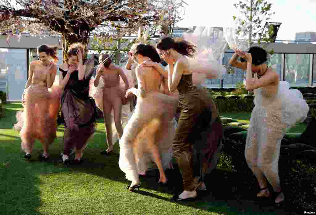 Models struggle against strong wind before the rehearsal of Christian Dior&#39;s Haute Couture Spring-Summer 2017 live show to celebrate Dior&#39;s new flagship store at the rooftop of Ginza Six mall in Tokyo, Japan.